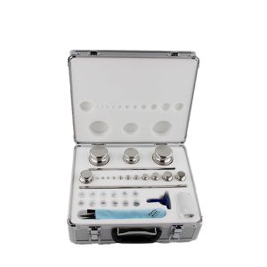 Open metal case revealing rows of precision tools arranged in slots, including small round tips and a blue-handled instrument at the bottom area.